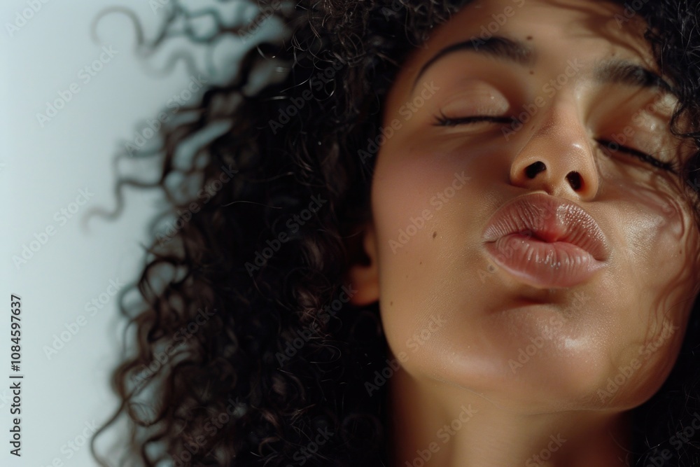 A close-up shot of a woman with her eyes shut, focused on something A close-up shot of a woman with her eyes shut, focused on something