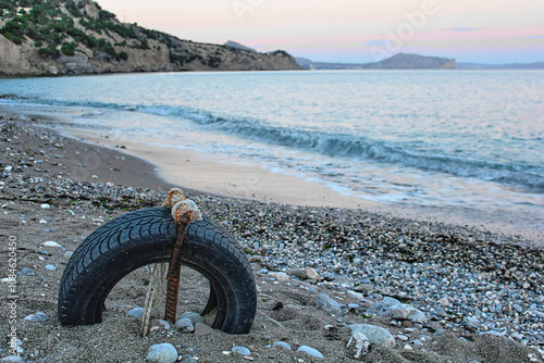 landscape vintage sea abstraction artifact old fisherman's wheel on the seashore