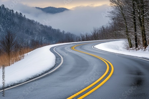 A snowy road with a mountain in the background