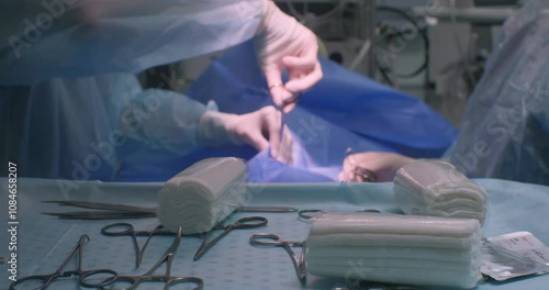 A veterinary surgeon secures the surgical field on a cat under anesthesia. Preparations are underway in the operating room for an operation on a cat to remove a foreign body from the intestines.