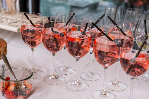 Glasses of wild berry sparkling wine drinks at a buffet at a wedding party photo