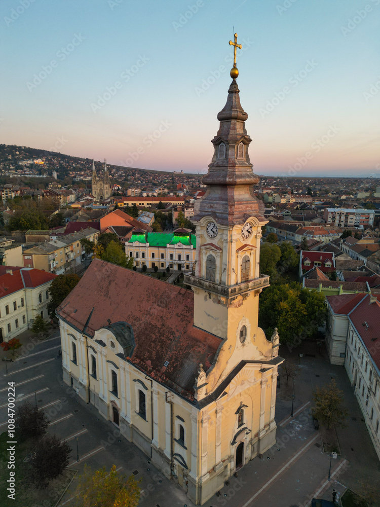 Obraz premium European bell tower with old red roof town in the background, Vršac, Serbia - aerial drone photo