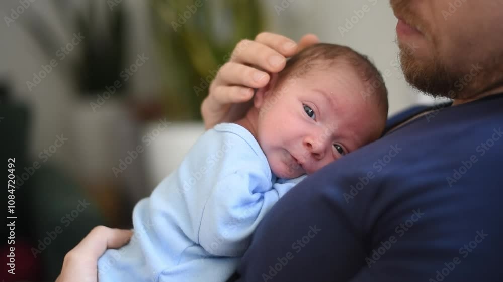 Father holding his newborn baby boy