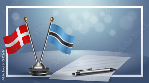 Denmark and Botswana National flags on small table with bokeh background, cooperative relationship