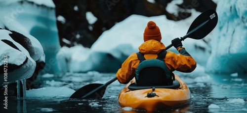 Wallpaper Mural Kayaking in icy waters, person in orange jacket paddling through icebergs, winter adventure, serene landscape Torontodigital.ca