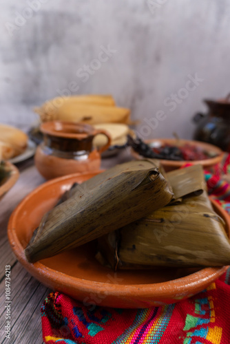 Variedad de tamales, de varios sabores y estilos en mesa, con atole y café platillo mexicano photo