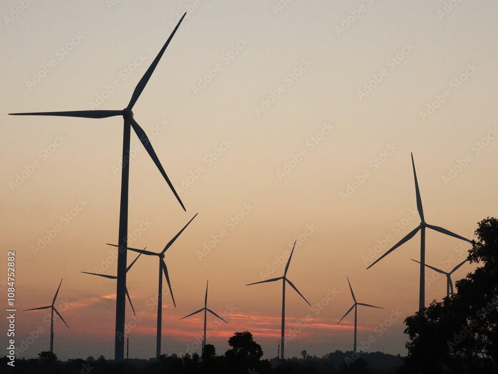 Obraz premium A wind turbine is a machine that converts kinetic energy from the movement of the wind and uses it to generate electricity by connecting it to a turbine or dynamo to generate electricity.