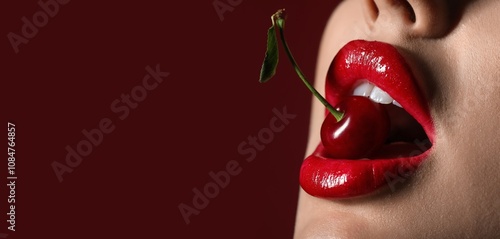 Fotografía Beautiful sexy woman with red lips and cherry on dark background with space for