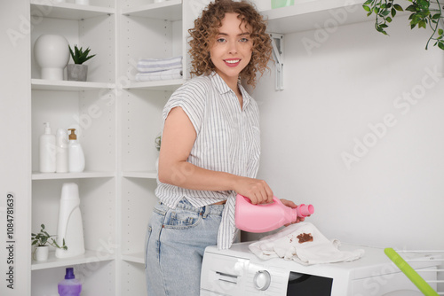 Young woman pouring stain r...