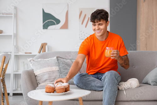 Young man with juice taking...