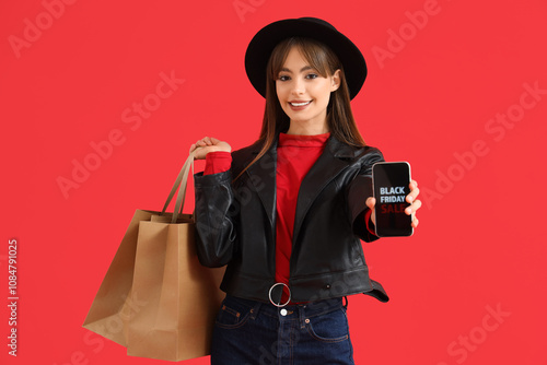 Smiling young woman holding...