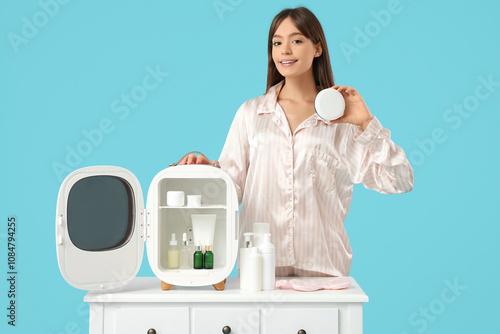 Young woman in pajamas hold...