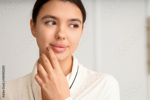 Beautiful young woman with soft lips at home, closeup