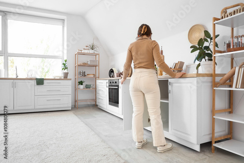Young woman opening white d...