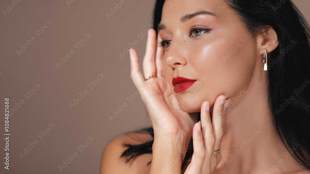 Elegant profile portrait of a woman with striking green eyes, red lips, and luxury jewelry. Ideal for beauty, fashion, and jewelry promotions, high-quality advertisements, and editorial use. Elegant profile portrait of a woman with striking green eyes, red lips, and luxury jewelry. Ideal for beauty, fashion, and jewelry promotions, high-quality advertisements, and editorial use.