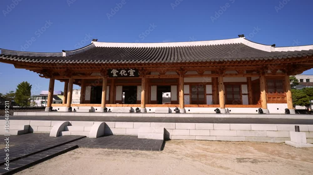 a traditional Korean pavilion with a tiled roof and wooden beams, situated in a courtyard with a stone pathway leading to its entrance, surrounded by a blend of traditional and modern architecture a traditional Korean pavilion with a tiled roof and wooden beams, situated in a courtyard with a stone pathway leading to its entrance, surrounded by a blend of traditional and modern architecture