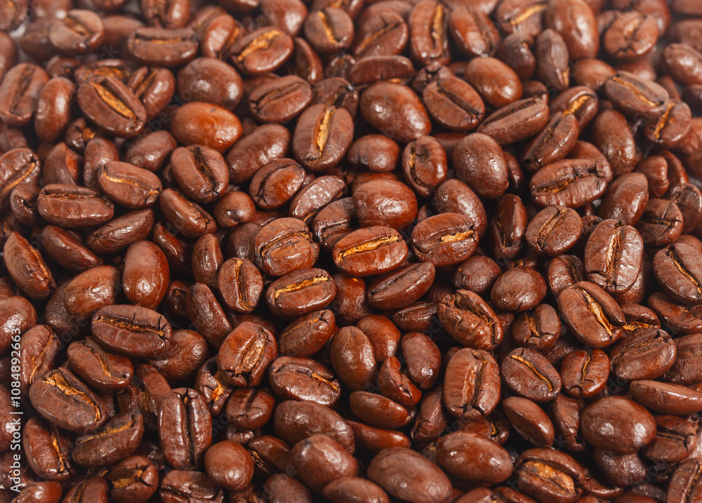 Fototapeta premium Full screen view, close up of a collection of roasted coffee beans, for background, illustration and pattern design.
