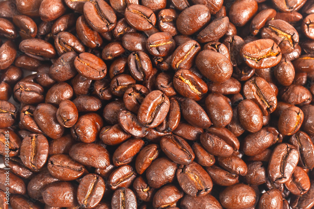 Fototapeta premium Full screen view, close up of a collection of roasted coffee beans, for background, illustration and pattern design.