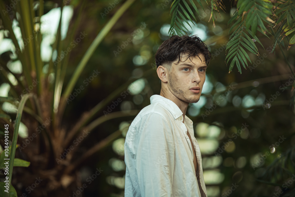 Young man with a concerned expression standing in a lush jungle, appearing lost. Wearing an open white shirt, he embodies themes of survival, exploration, and adventure. Ideal for high-quality Young man with a concerned expression standing in a lush jungle, appearing lost. Wearing an open white shirt, he embodies themes of survival, exploration, and adventure. Ideal for high-quality