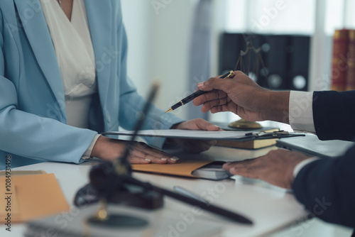 Legal Counsel: A focused close-up of a lawyer pointing to a document, guiding a client through legal proceedings with professionalism and expertise. 