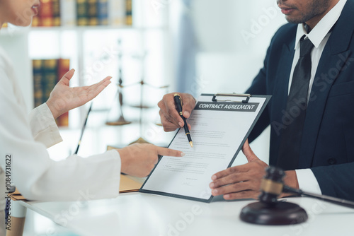 Legal Consultation:  A lawyer attentively explains legal documents to a client, ensuring a clear understanding.  The gavel subtly emphasizes the gravity of the situation.