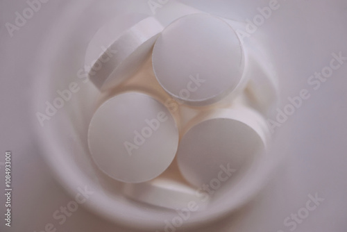 Medicine capsule tablets. Many different pills falling on white background photo