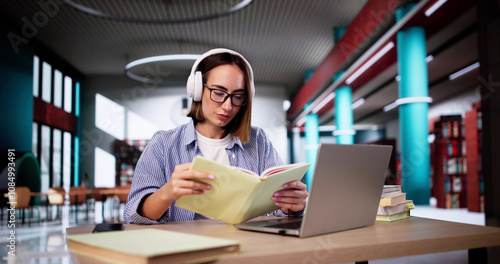 University Student In Library With Laptop photo