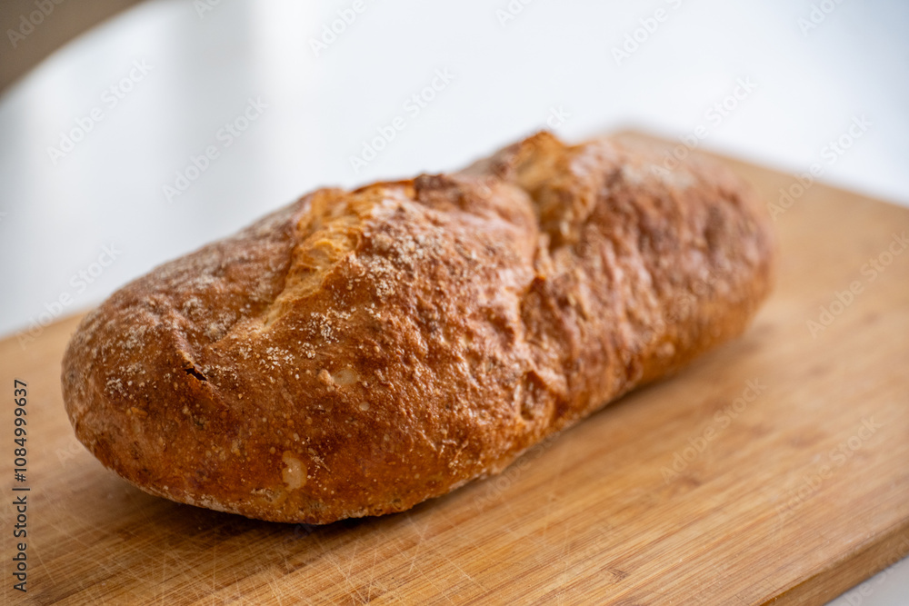Rustic organic bread on a wooden old board Rustic organic bread on a wooden old board