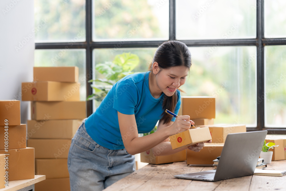 Entrepreneurial Spirit: A young woman runs her small business with a smile, preparing packages for delivery. She is surrounded by boxes and a laptop, showcasing the hustle of a modern entrepreneur. Entrepreneurial Spirit: A young woman runs her small business with a smile, preparing packages for delivery. She is surrounded by boxes and a laptop, showcasing the hustle of a modern entrepreneur.