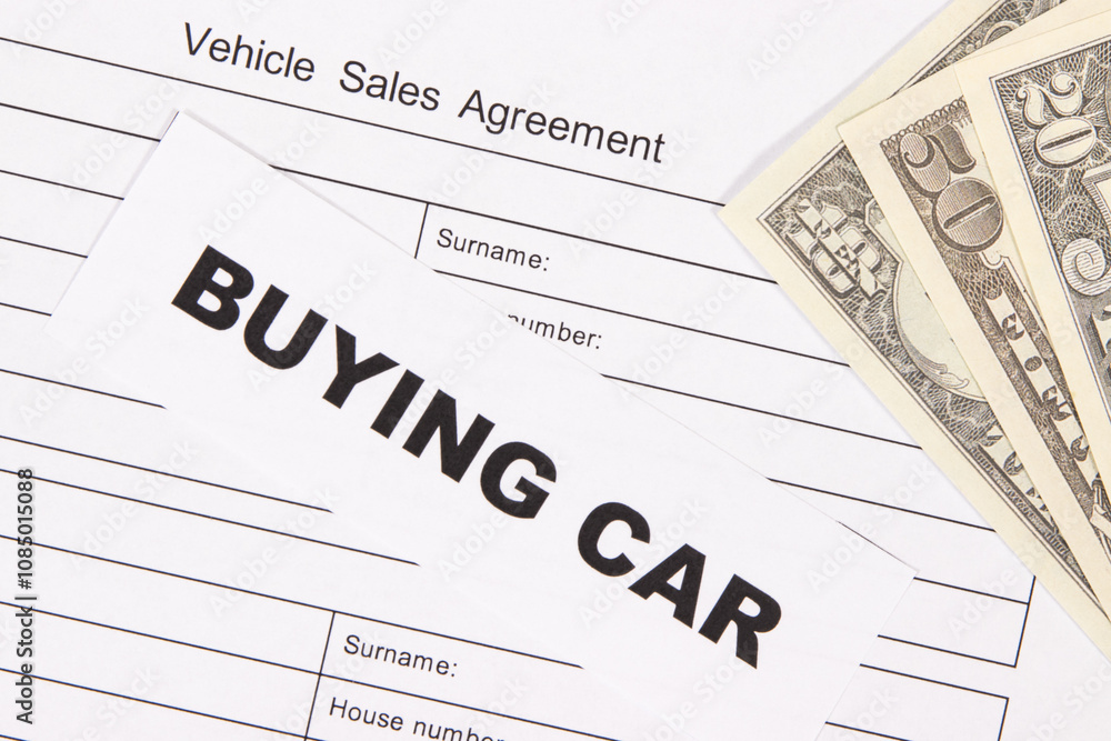 Form of vehicle sales agreement, inscription buying car and dollar banknotes. Sales, buying car Form of vehicle sales agreement, inscription buying car and dollar banknotes. Sales, buying car