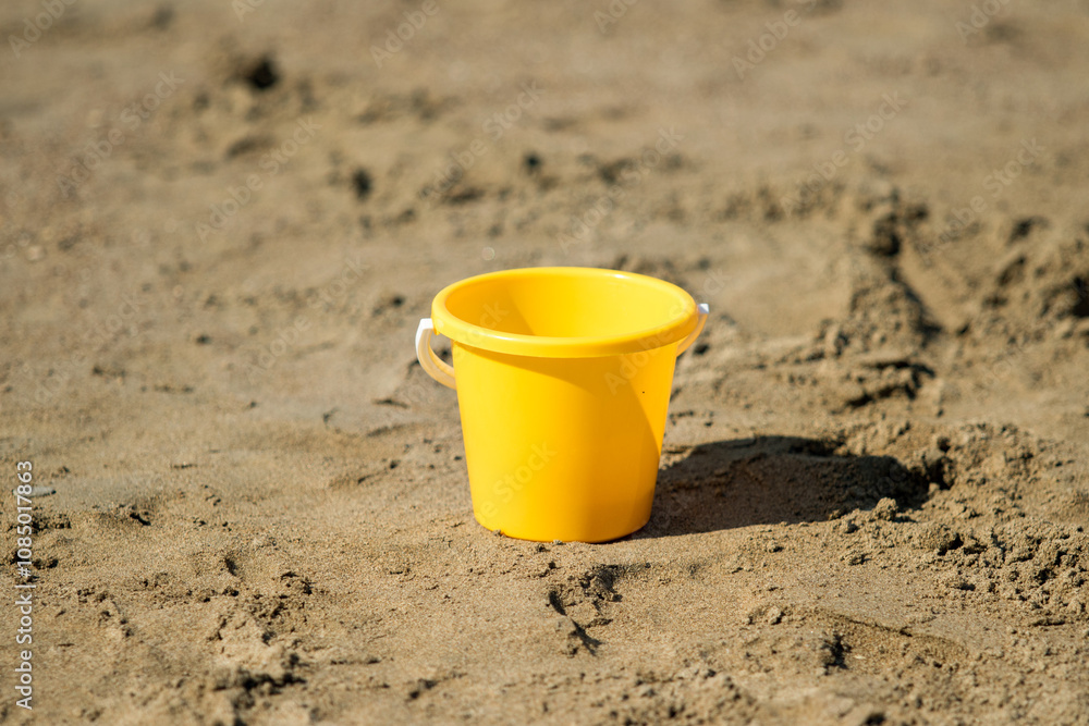 yellow plastic bucket on beach yellow plastic bucket on beach