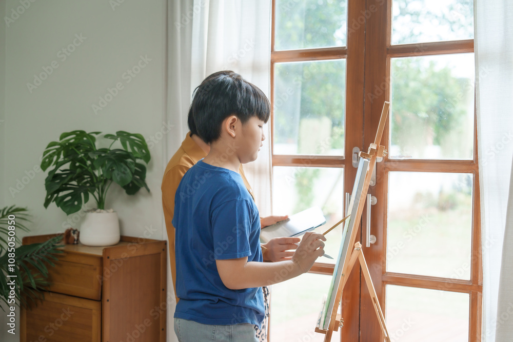 A mother teaches her young son art at home, smiling warmly as they enjoy painting together using an easel, creating colorful memories and strengthening their bond in a creative environment A mother teaches her young son art at home, smiling warmly as they enjoy painting together using an easel, creating colorful memories and strengthening their bond in a creative environment