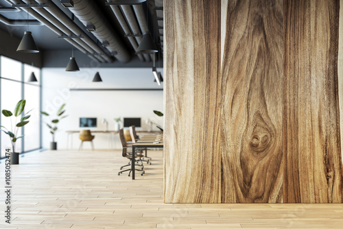 Photos Modern office interior with wooden wall, open workspace, and large windows providing natural light, corporate design
