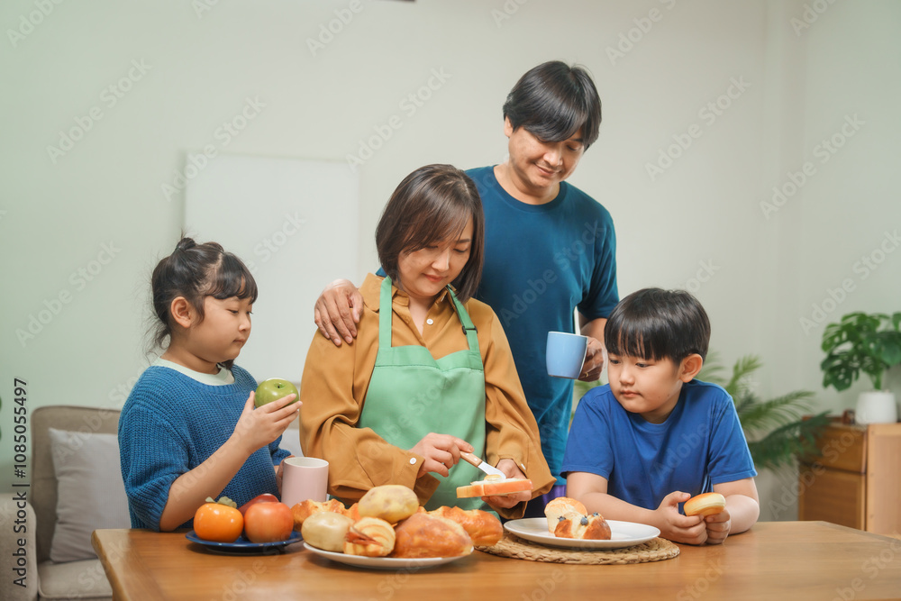 Asian parents and their children sit together at the table in the morning, studying online using tablets and computers, fostering a productive and focused family learning environment Asian parents and their children sit together at the table in the morning, studying online using tablets and computers, fostering a productive and focused family learning environment