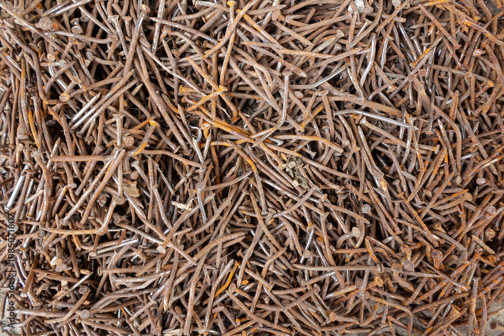 Pile of Rusty Nails from Construction on Concrete Surface Pile of Rusty Nails from Construction on Concrete Surface