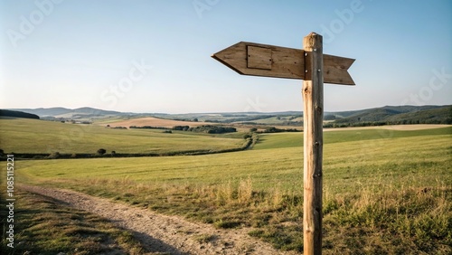Wooden arrow sign post standing in a field, entrance, path, countryside, field, trail