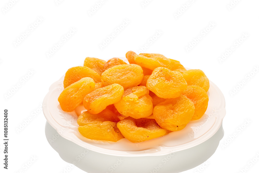 Sweet dried apricots on a ceramic plate, close-up, isolated on a white background. Sweet dried apricots on a ceramic plate, close-up, isolated on a white background.