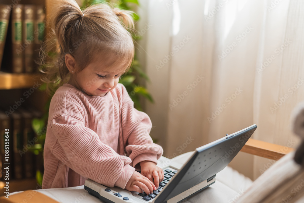 Adorable Little Girl Discovering Technology Through Play, Using A Toy Laptop At Home Adorable Little Girl Discovering Technology Through Play, Using A Toy Laptop At Home