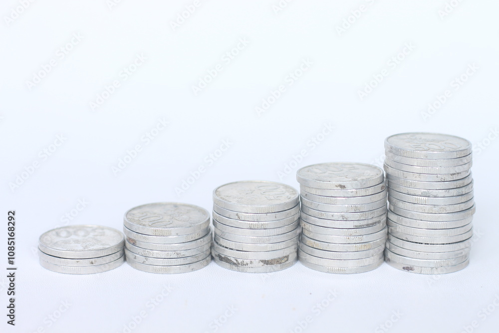 Silver coins stacks isolated on a white background. Indonesian rupiah coin. 500 rupiah coin. metal money Silver coins stacks isolated on a white background. Indonesian rupiah coin. 500 rupiah coin. metal money