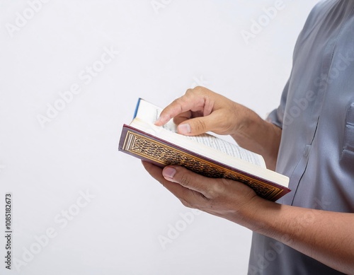 a Muslim holding the Koran, reflects religious values, tranquility, and spiritual connection photo