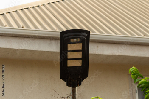 lamp on metal post in front of yellow residential building  photo