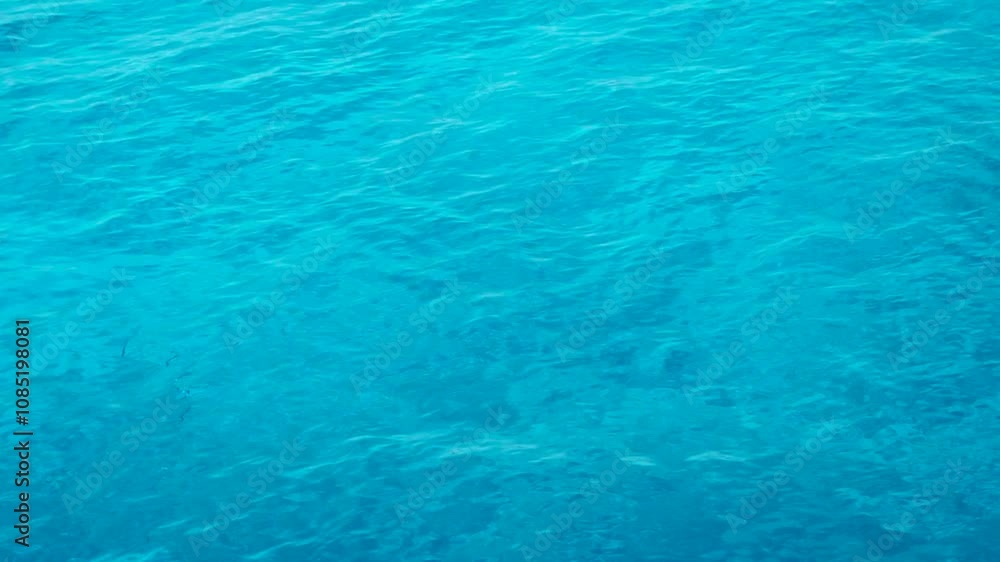Slow motion close up of calm transparent blue ocean water surface near Lakshadweep, India. Turquoise water background. Slow motion close up of calm transparent blue ocean water surface near Lakshadweep, India. Turquoise water background.