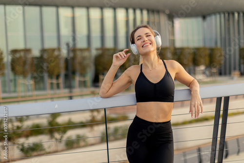 A joyful young woman enjoyi...