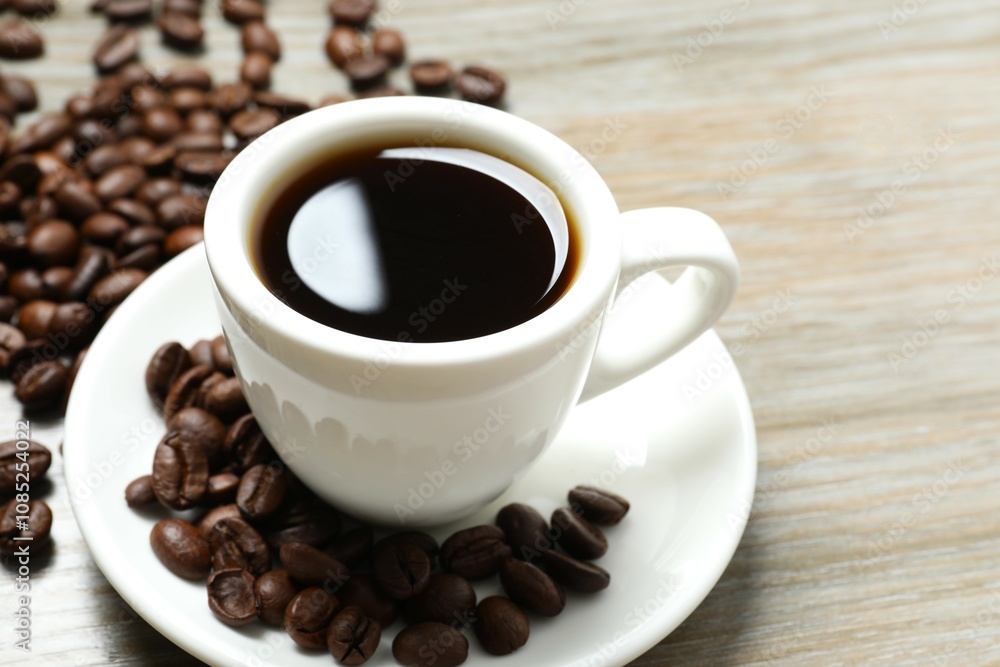 Cup of coffee and coffee beans on wooden background Cup of coffee and coffee beans on wooden background