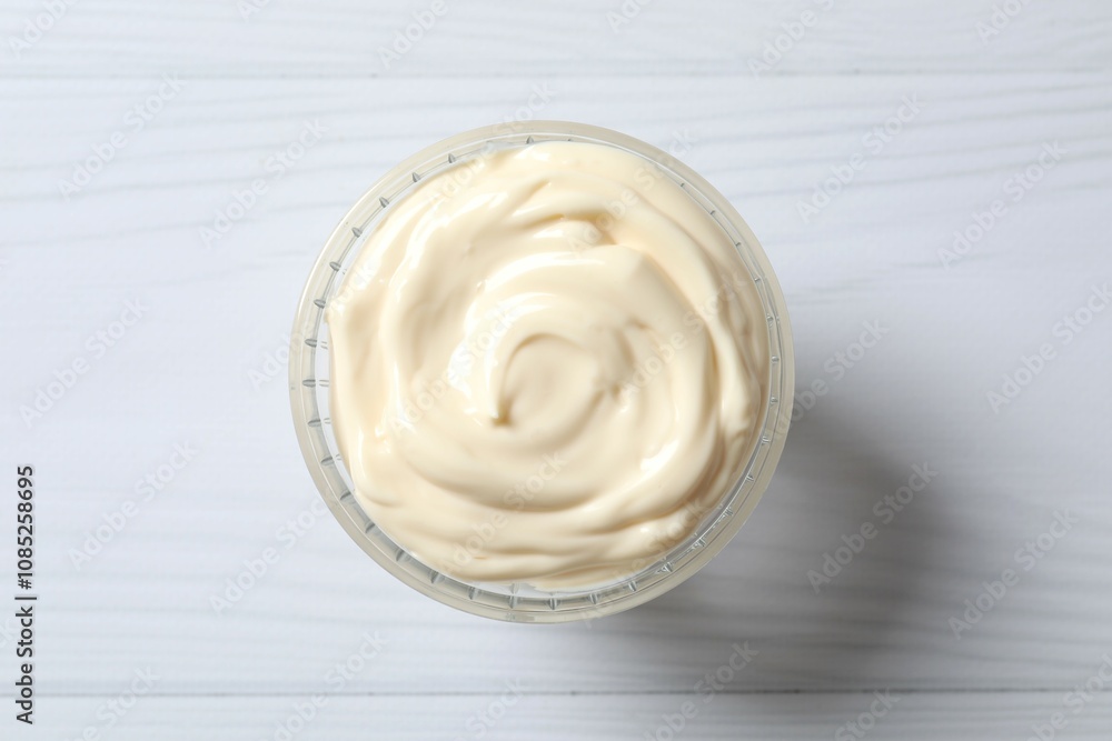 Bowl with mayonnaise and ingredients for cooking on white background Bowl with mayonnaise and ingredients for cooking on white background