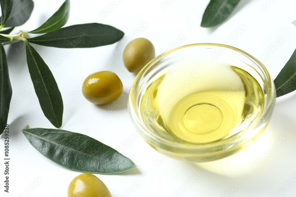 Bowl of fresh olive oil and olives on white background Bowl of fresh olive oil and olives on white background
