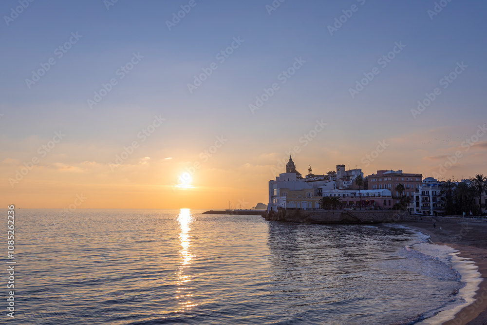 Beautiful sunset over the ocean with a small town in the background Beautiful sunset over the ocean with a small town in the background