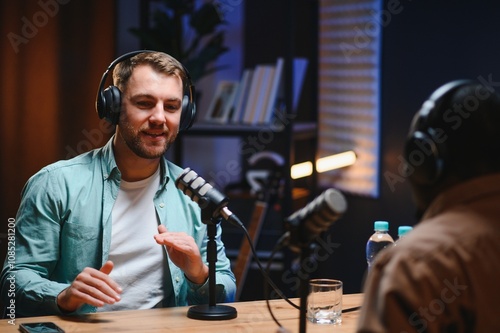 Man recording podcast using high tech microphones to interview guest, ensuring flawless video and sound quality for audience photo