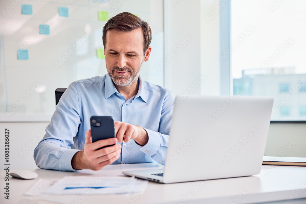 Businessman working at office using mobile phone l Businessman working at office using mobile phone l