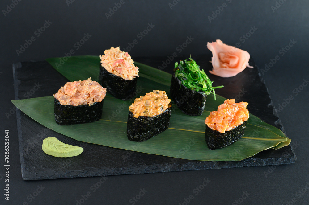 sushi, japanese food, sushi on sticks, sushi sprinkled with sesame seeds, many different sushi and rolls on a plate, on a banana leaf sushi, japanese food, sushi on sticks, sushi sprinkled with sesame seeds, many different sushi and rolls on a plate, on a banana leaf